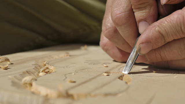 a person carving wood