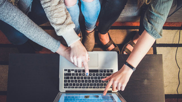 young people pointing at a laptop screen