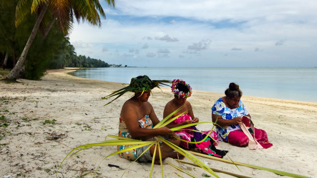 women sitting on a beach in Cook Islands