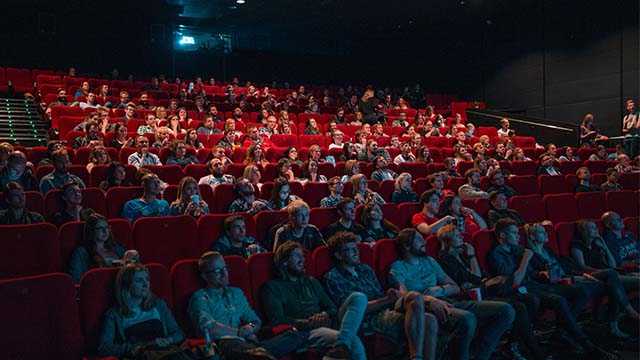 People sitting in movie theatre