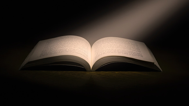 book lit by stream of light