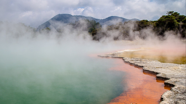 steam rising from geothermal lake