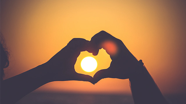 silhouette of hands in heart shape