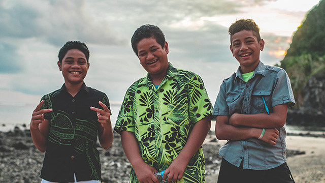 Three young people on beach