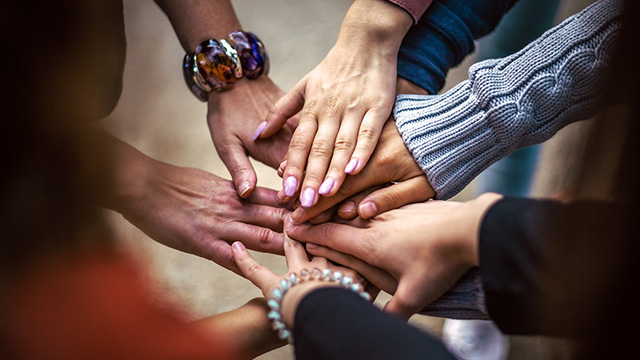people placing their hands together