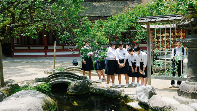 students standing by pond