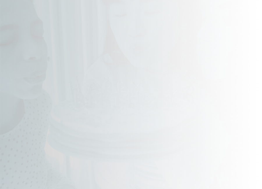 Three young people blowing out the candles on a birthday cake