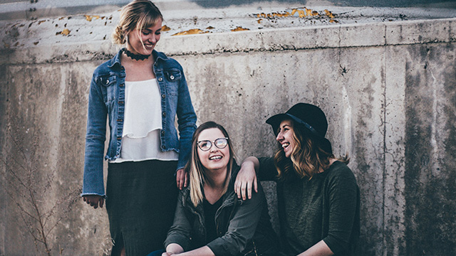 three friends smiling