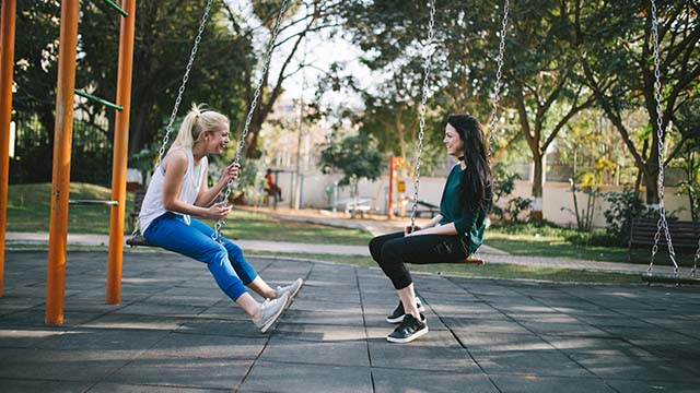 two people on swings