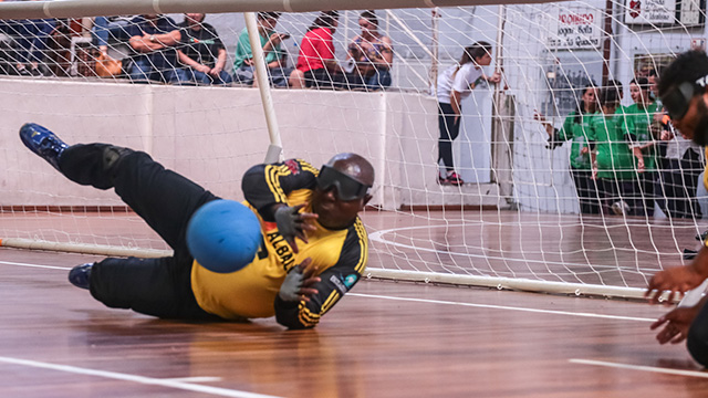 player reaching for the goalball