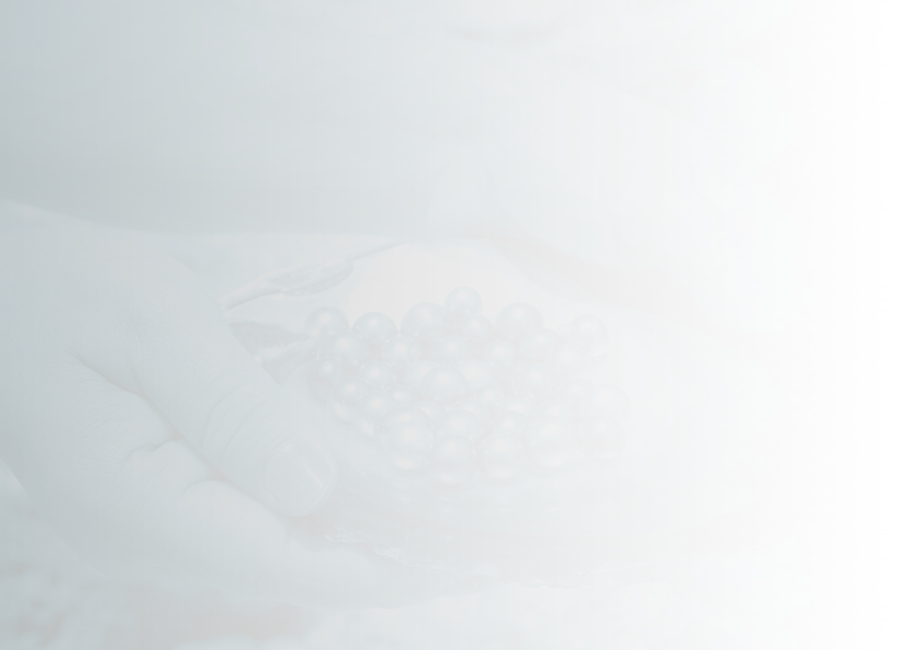 hands holding shell with pearls