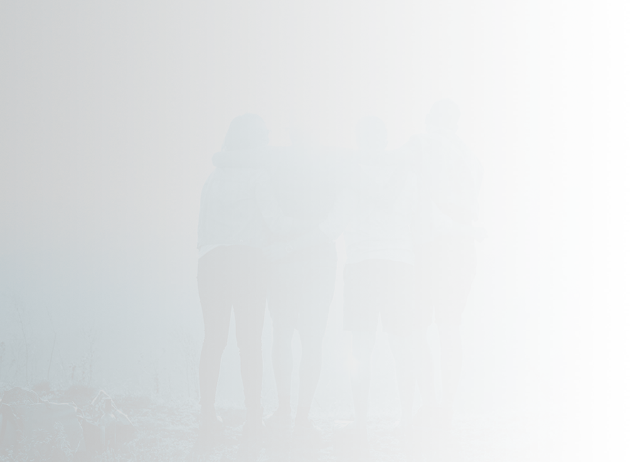 group of people standing together with arms around each other