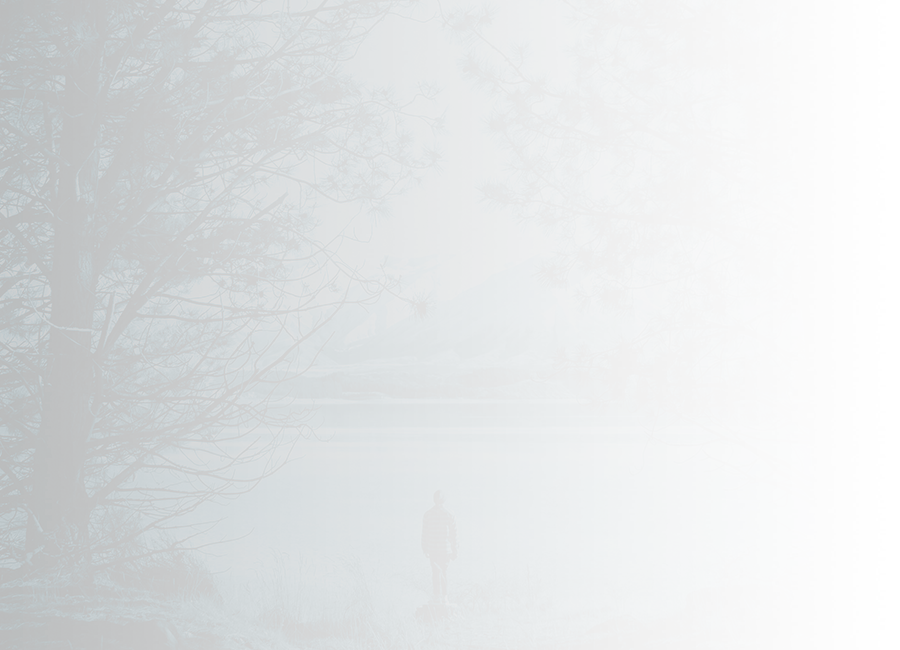 person alone looking out to lake and mountains