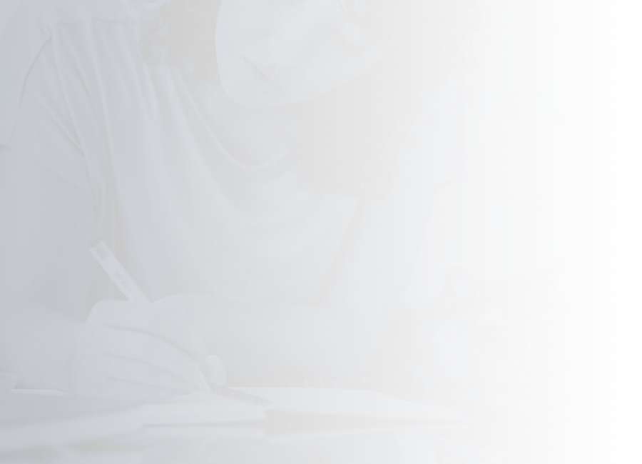young woman writing in notebook and sitting next to a cat